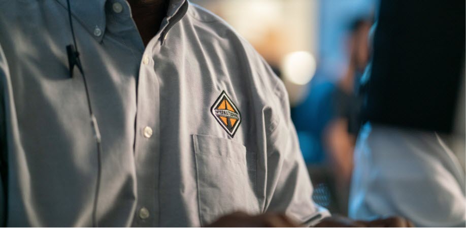 Photo of an  International Trucks employee wearing a shirt with the logo on the front